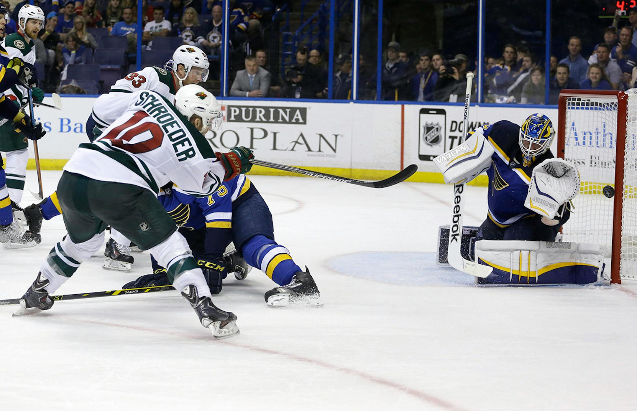 Minnesota Wild's Jordan Schroeder, left,