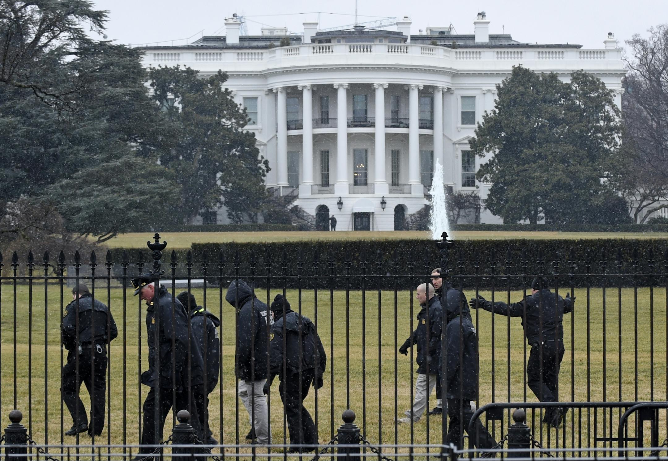 Secret Service officers search the south grounds of the White House in Washington, Monday, Jan. 26, 2015. A device, possibly an unmanned aerial drone, was found on the White House grounds during the middle of the night while President Barack Obama and the first lady were in India, but his spokesman said Monday that it posed no threat.