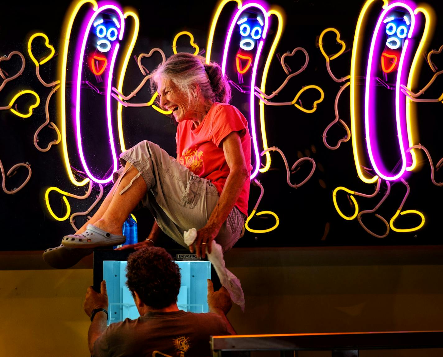 Ann Chesin laughed when she realized she was stuck on top of a cooler after wiping down the dancing neon hot dogs at her Chico Dogs food stand at the Fair. She did eventually get down with the help of husband Bruce. This will be their 16th season. The opening of the 2014 Minnesota State Fair is less than a week away and the place is hopping. ] Thursday, August 14, 2014. GLEN STUBBE * gstubbe@startribune.com