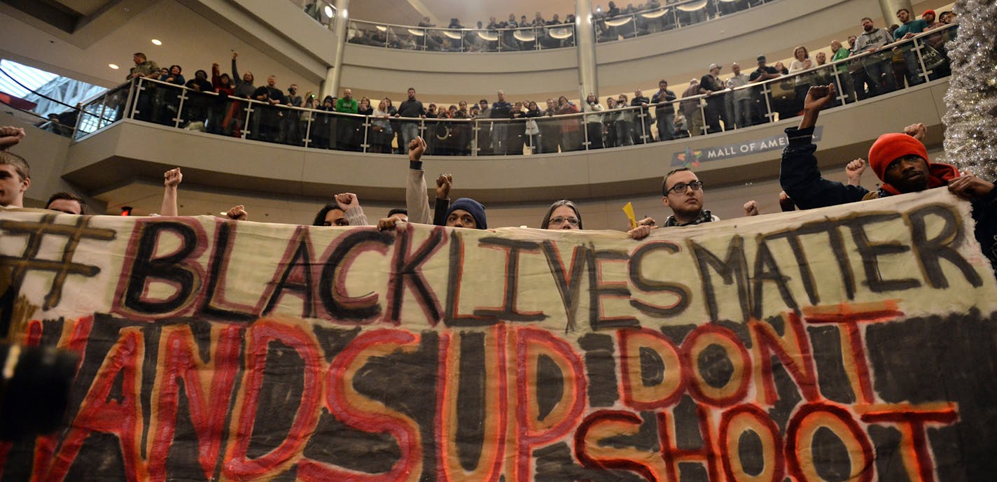 Demonstrators filled the Mall of America rotunda and chanted "Black lives matter" to protest police brutality, Saturday, Dec. 12, 2014, in Bloomington, Minn. The group Black Lives Matter Minneapolis had more than 3,000 people confirm on Facebook that they would attend. Attendance figures weren't immediately available. (AP Photo/The Star Tribune, Aaron Lavinsky) ORG XMIT: MIN2015011814105351 ORG XMIT: MIN1501181430293903