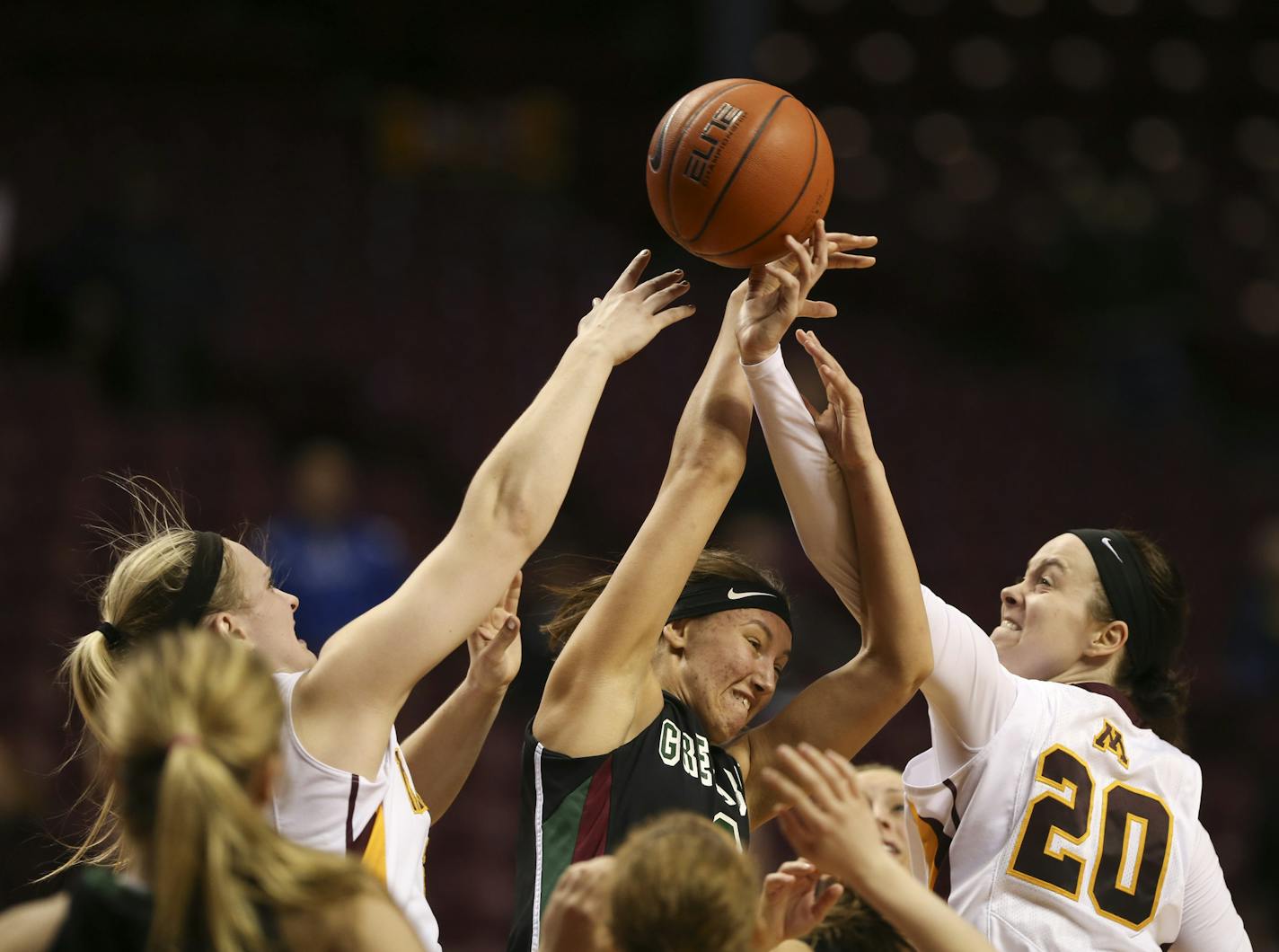 Gophers guard Sari Noga (21) and Gophers guard/forward Kayla Hirt (20) fought for control of a rebound.