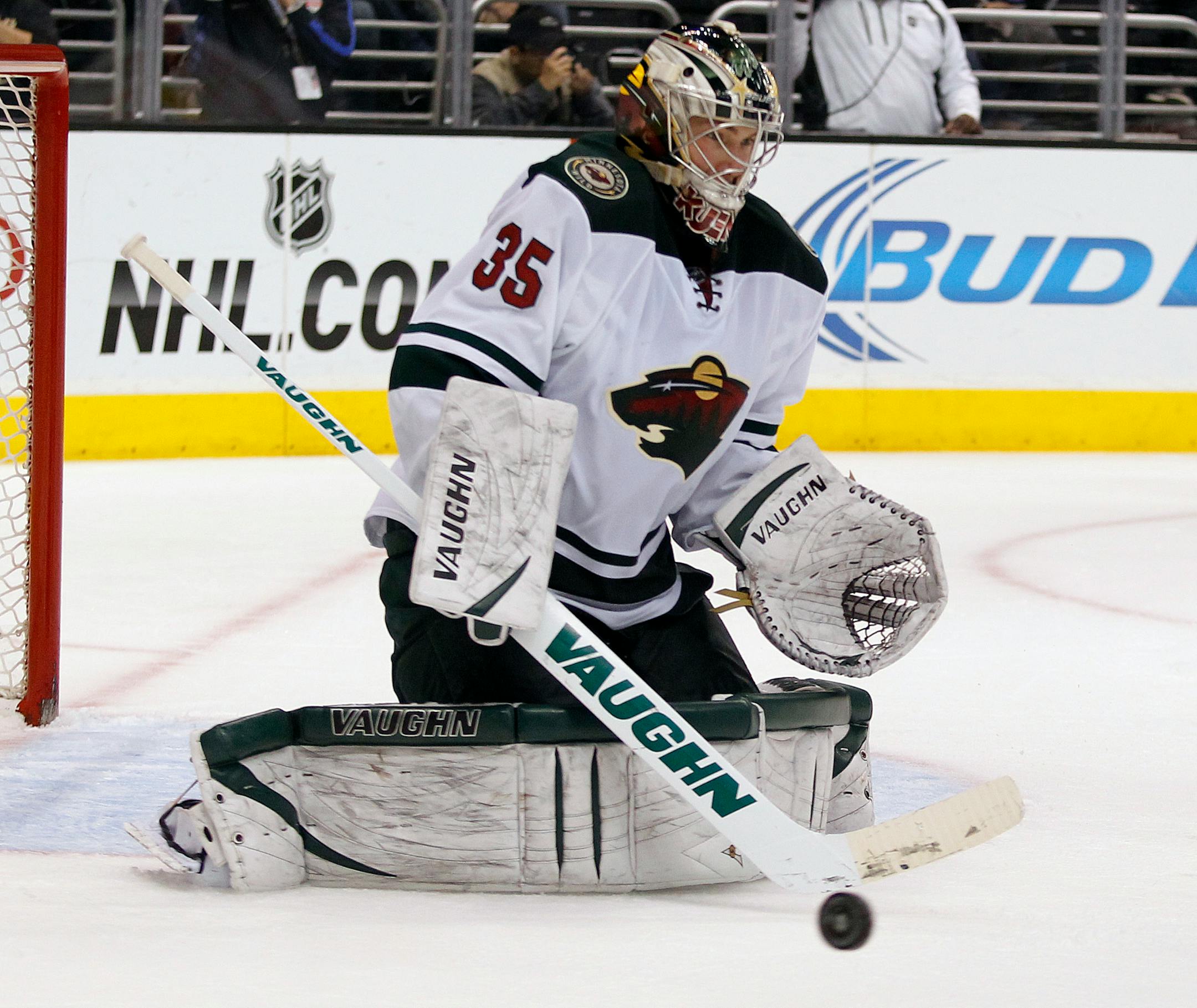 Minnesota Wild goalie Darcy Kuemper makes a stick save against the Los Angeles Kings during the second period of an NHL hockey game Tuesday, Jan. 7, 2014, in Los Angeles. (AP Photo/Alex Gallardo)