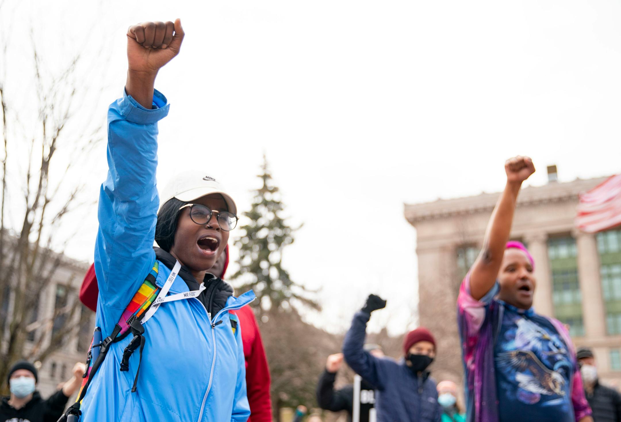Quita Leach, the protest organizer, raised her fist with fellow community members as they chanted in front of Duluth City Hall.