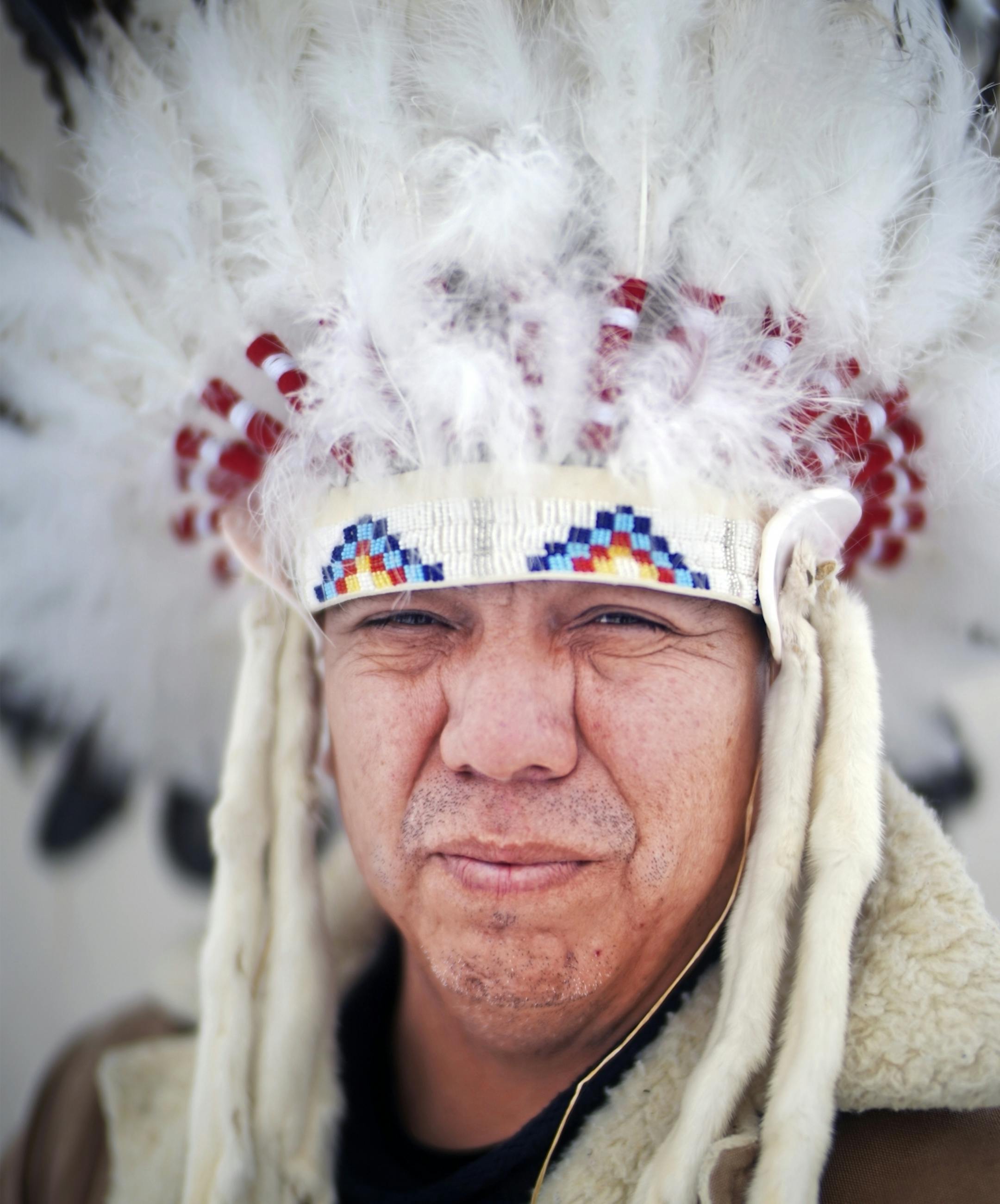 Lance King is a Lakota Sioux who lived in the Twin Cities for 26 years and recently moved back to Kyle, on the Pine Ridge Reservation to assume his lineage as the descendant of Chief Mathew King, Noble Red Man. "I am bringing that spiritualism with me. The traditional ways are still here." He is wearing a Wapaha or chief headdress.