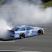 Kasey Kahne (5) does a burn out after winning a NASCAR Sprint Cup Series auto race Sunday at Pocono Raceway.