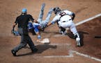 Umpire Vic Carapazza called Kansas City Royals second baseman Nicky Lopez (1) safe and the seventh inning as Minnesota Twins catcher Jason Castro (15)