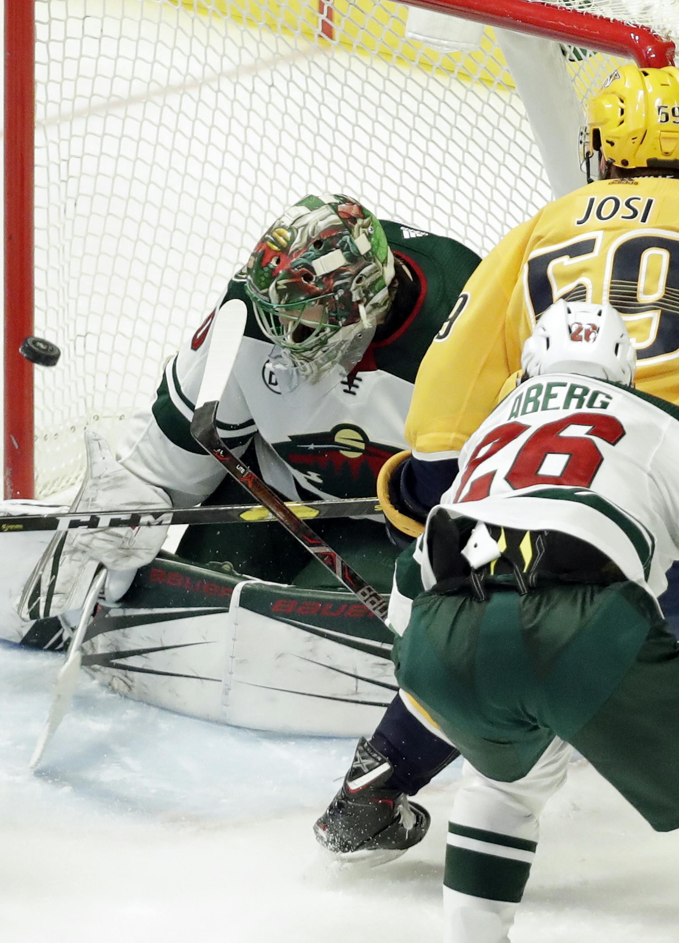Nashville Predators defenseman Roman Josi (59), of Switzerland, scores a goal against Minnesota Wild goaltender Devan Dubnyk in the third period of an NHL hockey game Tuesday, March 5, 2019, in Nashville, Tenn. Also defending for the Wild is Pontus Aberg (26), of Sweden. (AP Photo/Mark Humphrey)