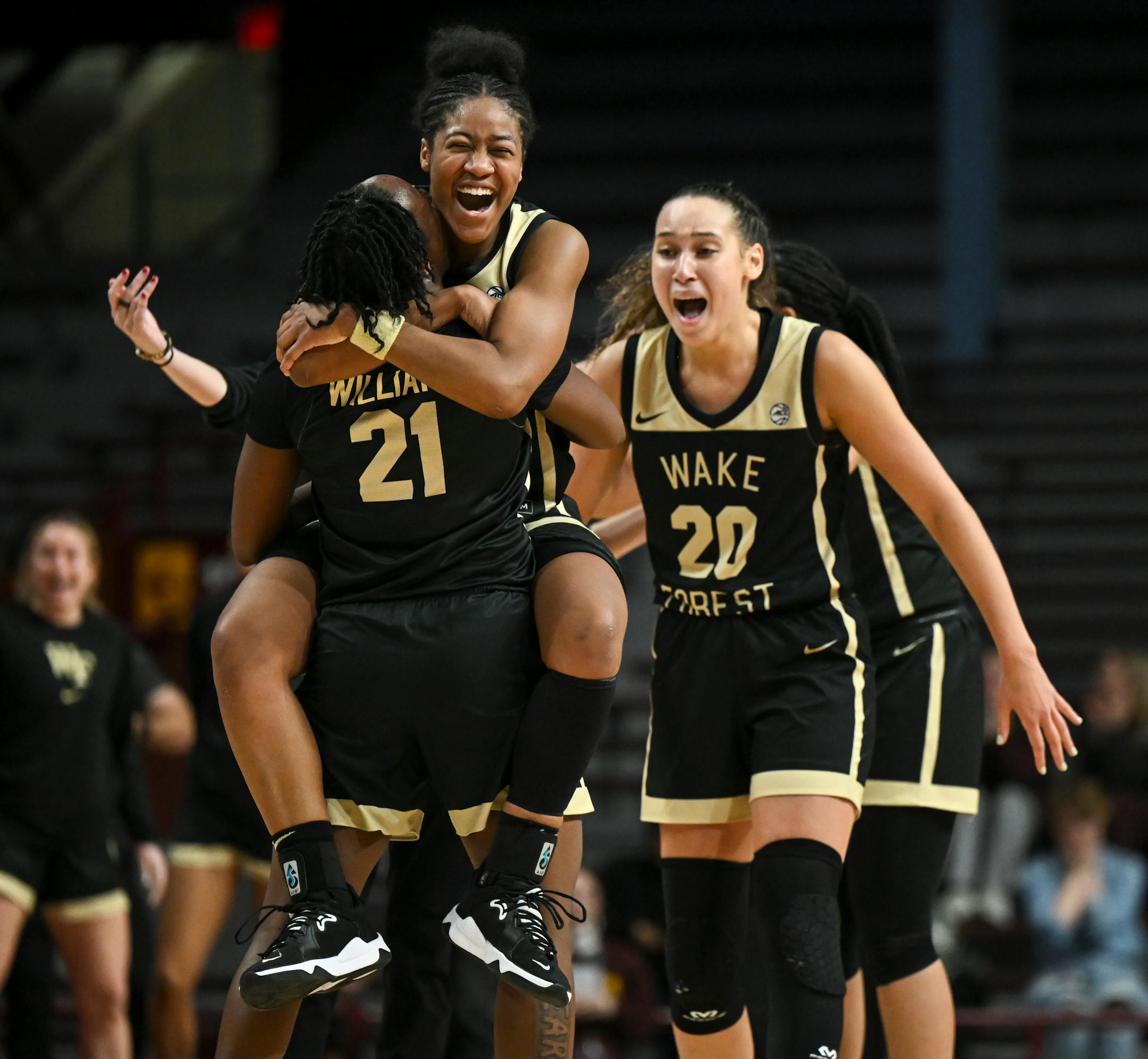 Wake Forest guard Jewel Spear (24) jumps into the arms of guard Elise Williams (21) after Spear hit a game-winning 3-pointer with less than five seconds remaining against the Minnesota Gophers during the second half.