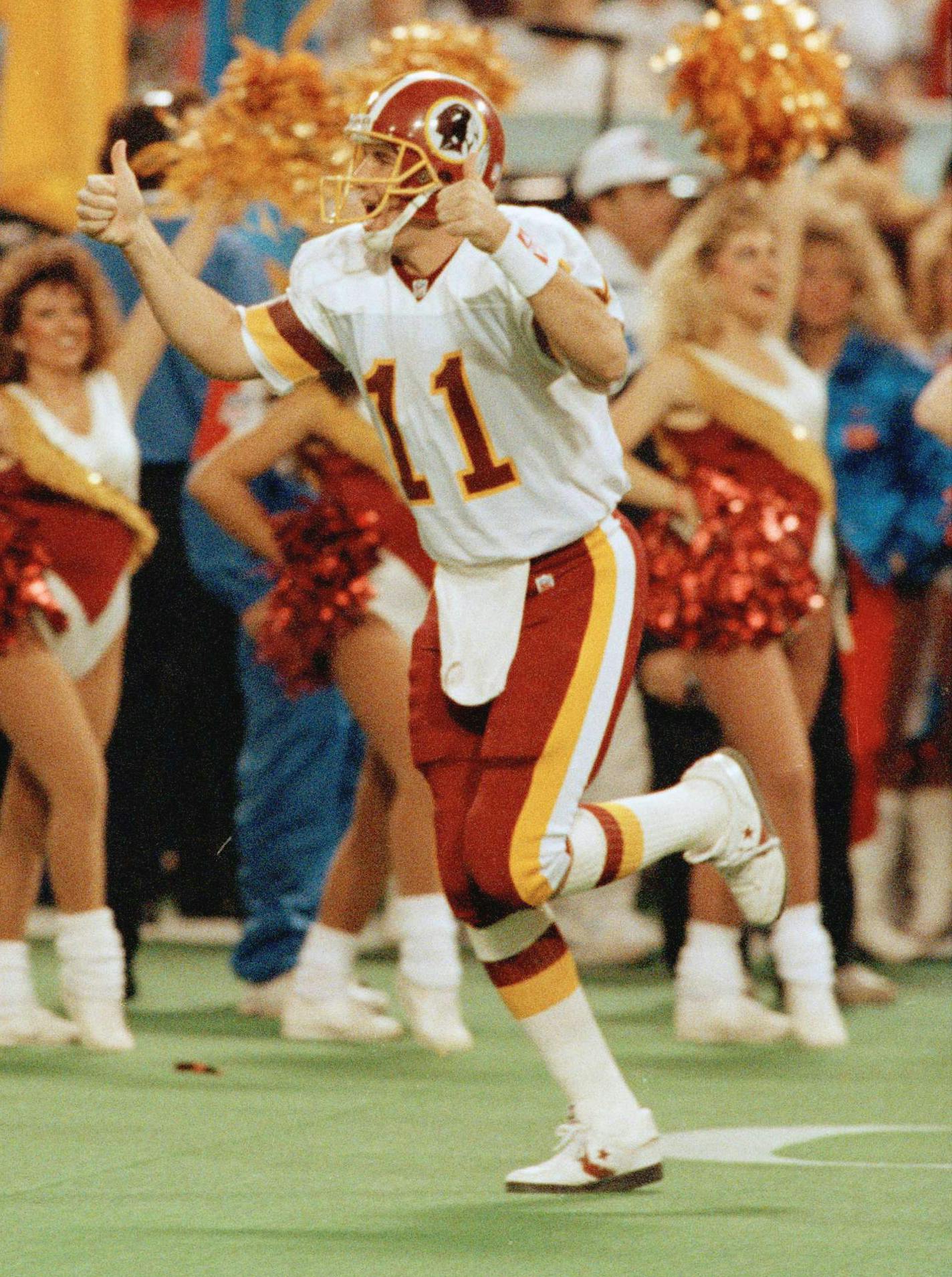 Washington Redskins quarterback Mark Rypien gives thumbs up as he enters the field before the start of Super Bowl XXVI at the Metrodome in Minneapolis Sunday, Jan. 26, 1992. (AP Photo/Rusty Kennedy) ORG XMIT: APHS33402