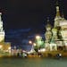 Moscow lights up at night with St. Basil&#x2019;s Cathedral, right, and the Kremlin clock tower, left.