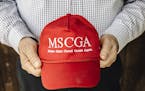 John Palmer holds a hat modeled after President Donald Trump's signature merchandise in St. Cloud, Minn., on May 16, 2019. As more Somali refugees arr