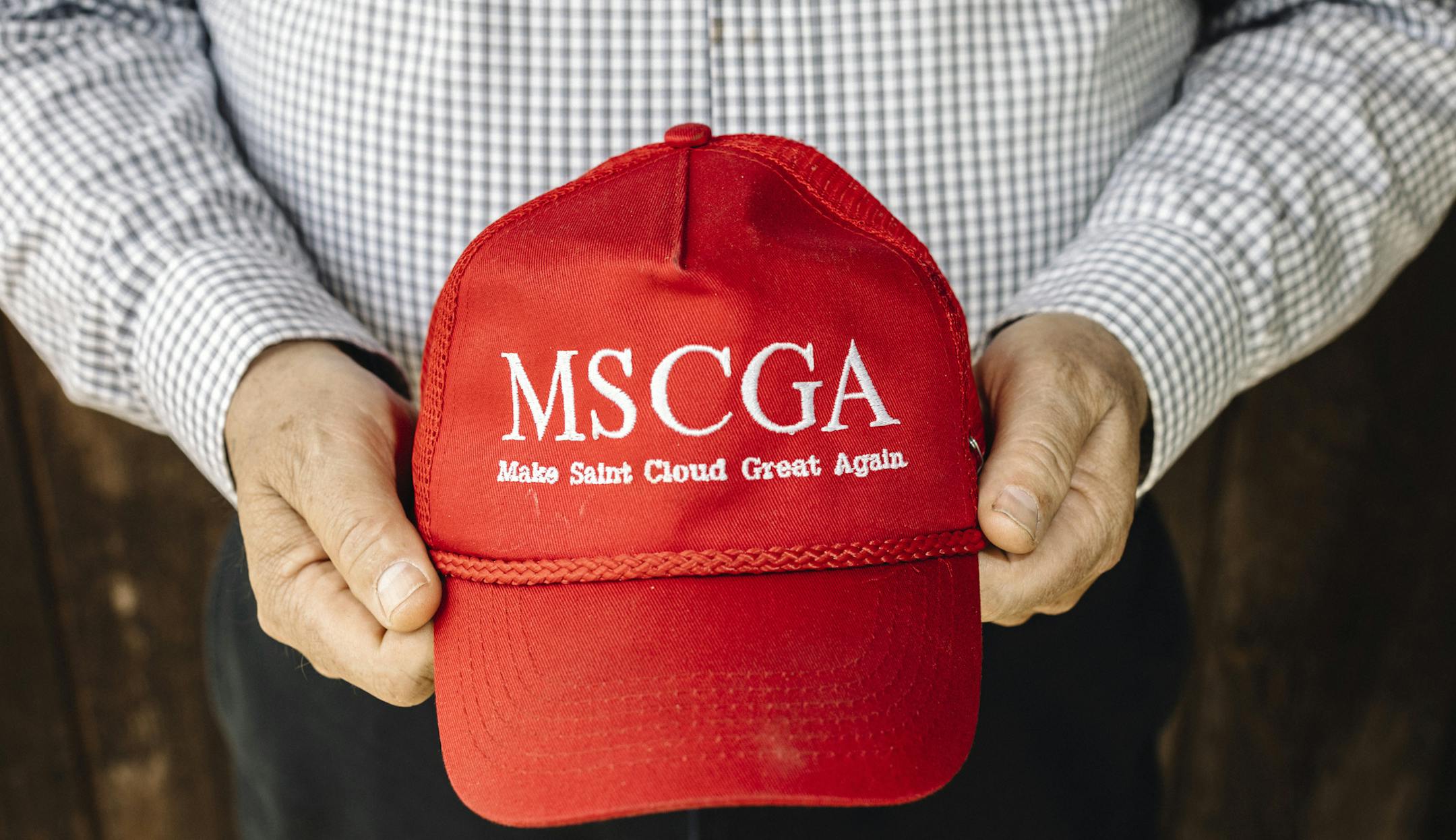 John Palmer holds a hat modeled after President Donald Trump's signature merchandise in St. Cloud, Minn., on May 16, 2019. As more Somali refugees arrive in St. Cloud, white anti-immigration activists have pressed an increasingly explicit anti-Muslim agenda. (William Widmer/The New York Times)