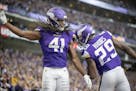 Vikings defensive back Anthony Harris, left, and cornerback Xavier Rhodes celebrate his interception in the Falcons end zone during the third quarter 