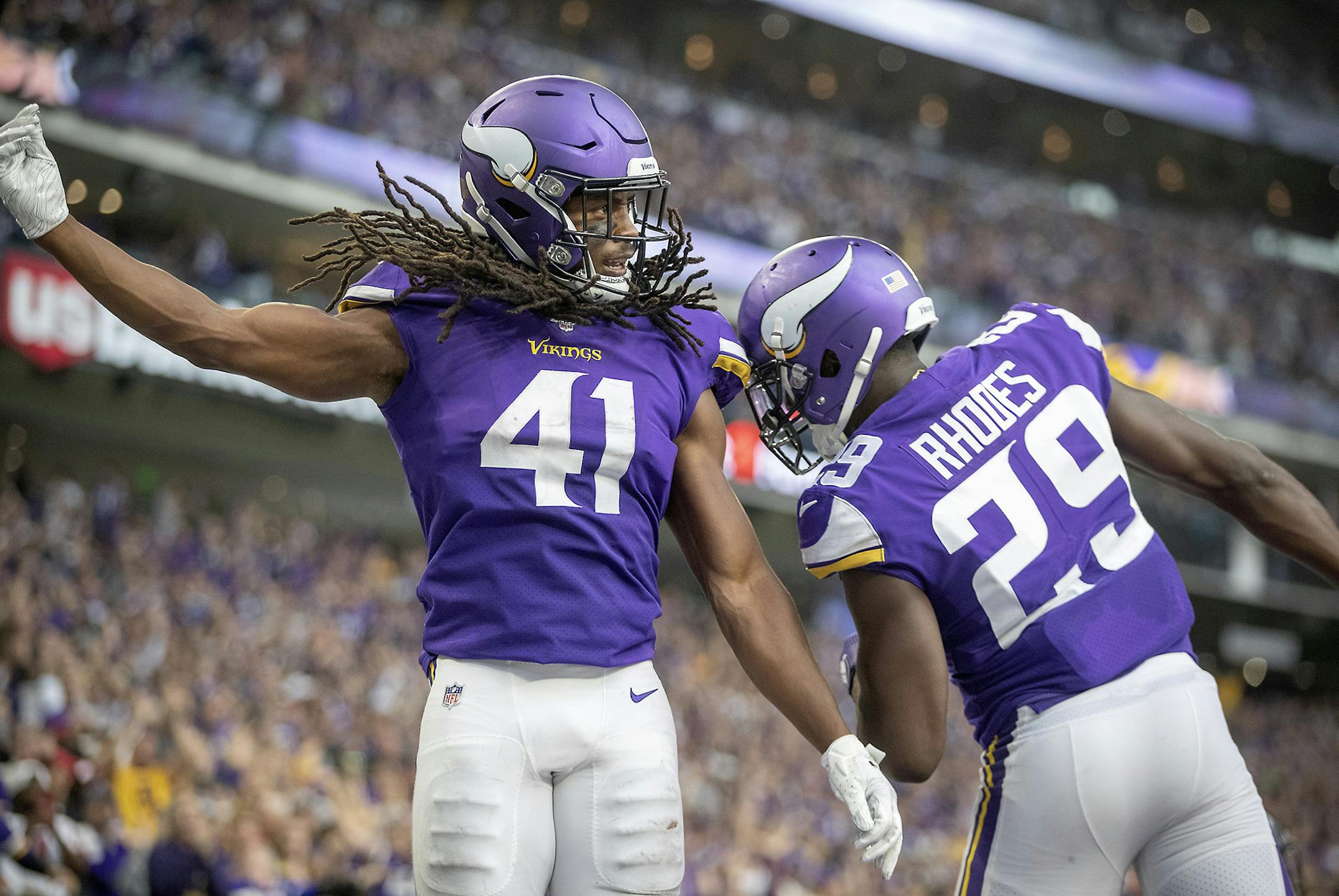 Vikings defensive back Anthony Harris, left, and cornerback Xavier Rhodes celebrate his interception in the Falcons end zone during the third quarter last Sunday