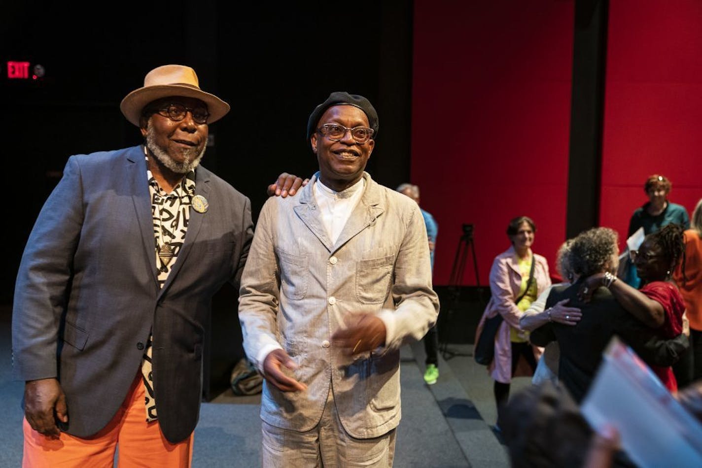 Artists Ta-coumba T. Aiken, left, and Seitu Jones pose for a photo together during the public unveiling event