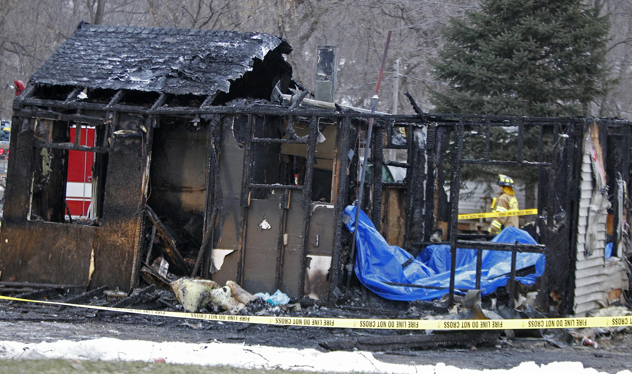 Firefighters worked the scene of a fire in Chanhassen, MN, Monday, March 17, 2014. ] (ELIZABETH FLORES/STAR TRIBUNE) ELIZABETH FLORES • eflores@startribune.com