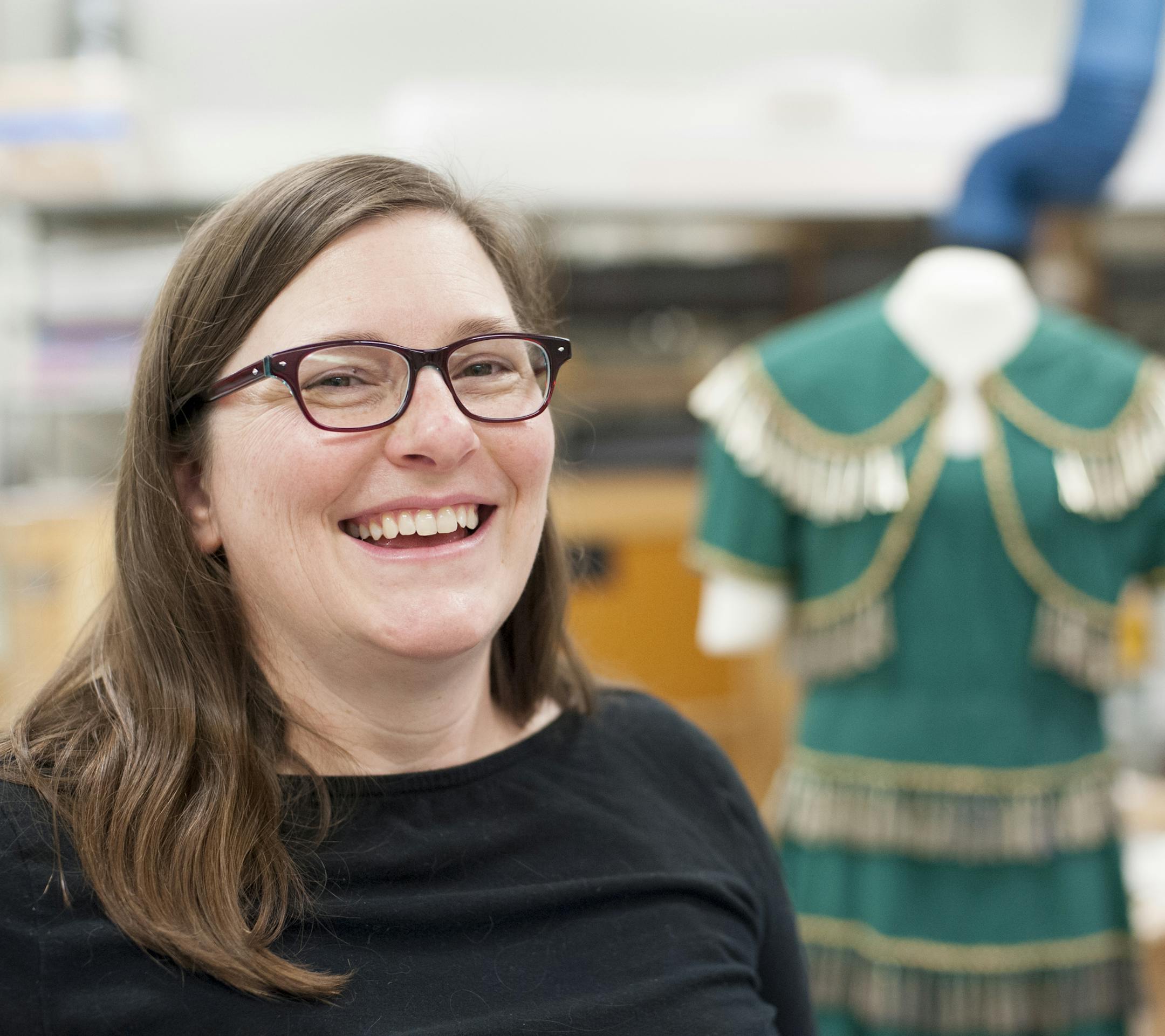 Rebecca Newberry works at the Science Museum behind-the-scenes projects like dusting the dinosaur bones. On April 8, 2015, she was dressing a doll for an upcoming event celebrating the science of beer (in the background). ] Photo by Leslie Plesser ï Special to the Star Tribune