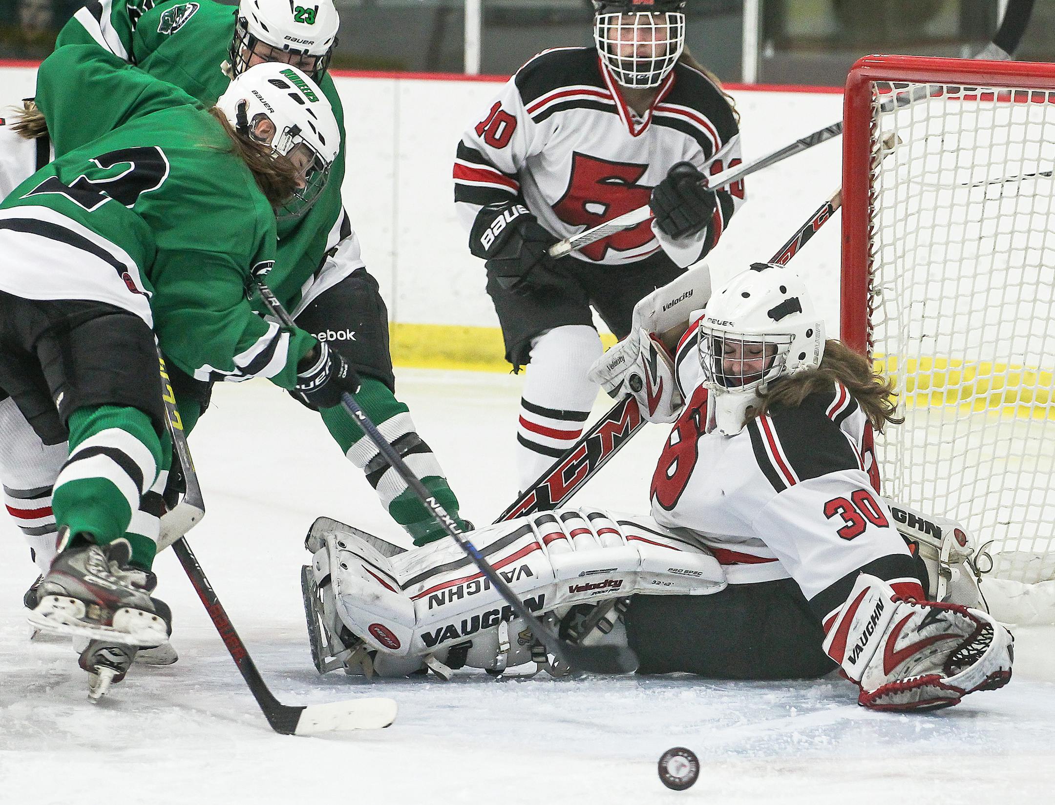 Eden Prairie goaltender Alexa Dobchuk protects the net as Hill-Murray's Amber Peterson (2) puts a shot on goal. Dobchuk had 26 saves as Eden Prairie beat Hill-Murray 4-2. Hill-Murray at Eden Prairie girls hockey, 11-15-16, photo by Mark Hvidsten, SportsEngine