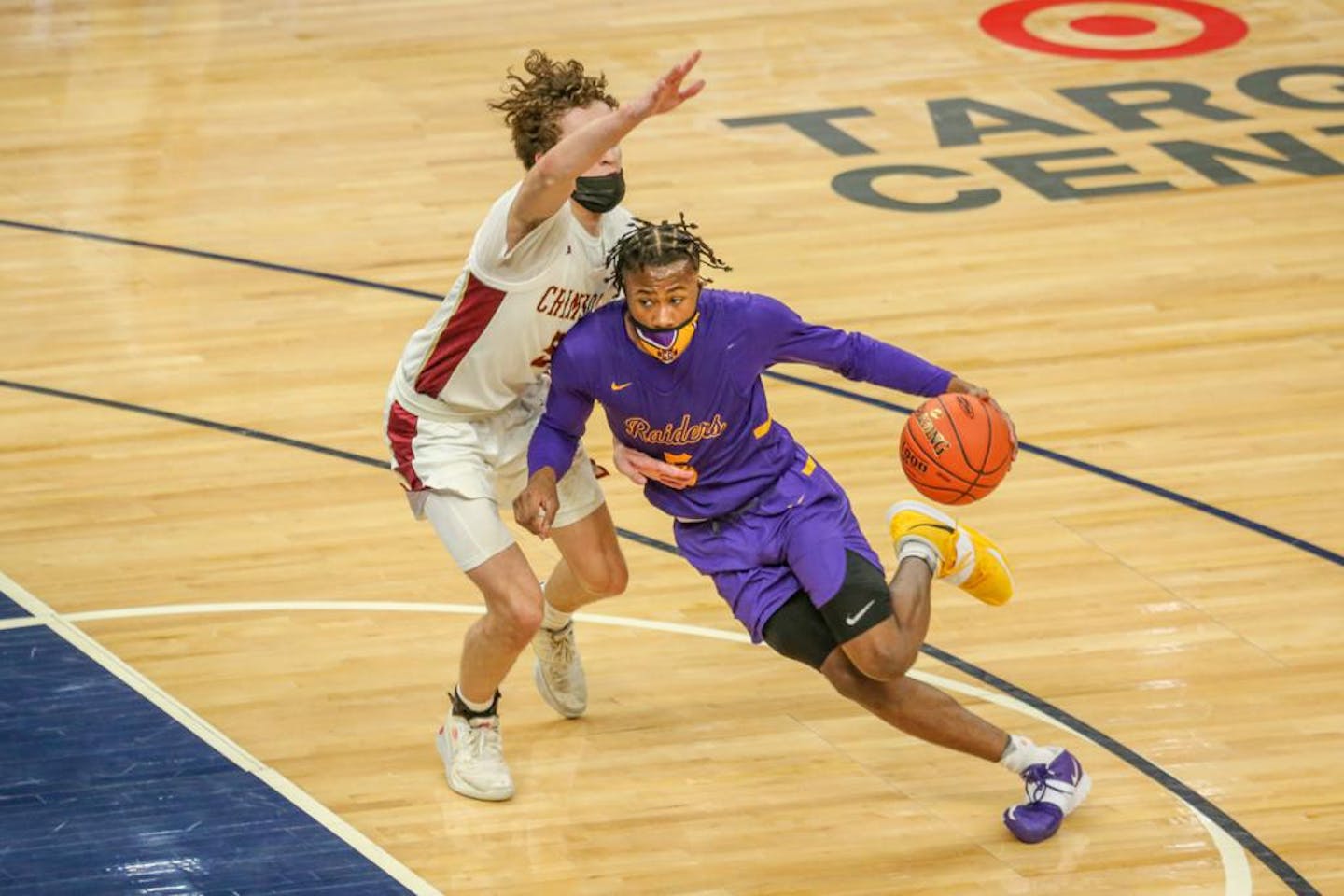 Cretin-Derham Hall's Tre Holloman (5) drives the lane against Maple Grove Thursday night at Target Center. Holloman had xx points in the Raiders' xx-xx victory over the Crimson. Photo by Jeff Lawler, SportsEngine