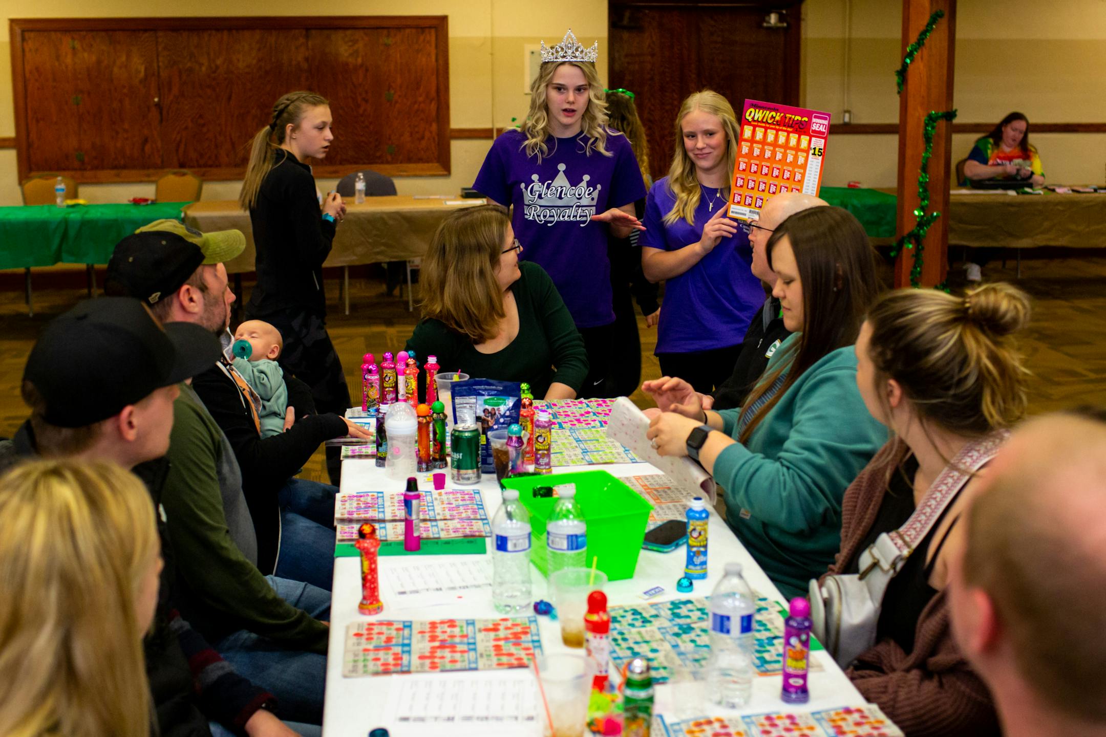 Members of Glencoe Royalty sell raffle tickets for cash prizes during Designer Purse & Gun Bingo.