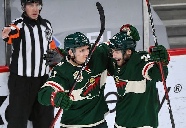 Minnesota Wild center Nico Sturm (7) and defenseman Carson Soucy (21) celebrated Soucy's third period goal against the Vegas Golden Knights.