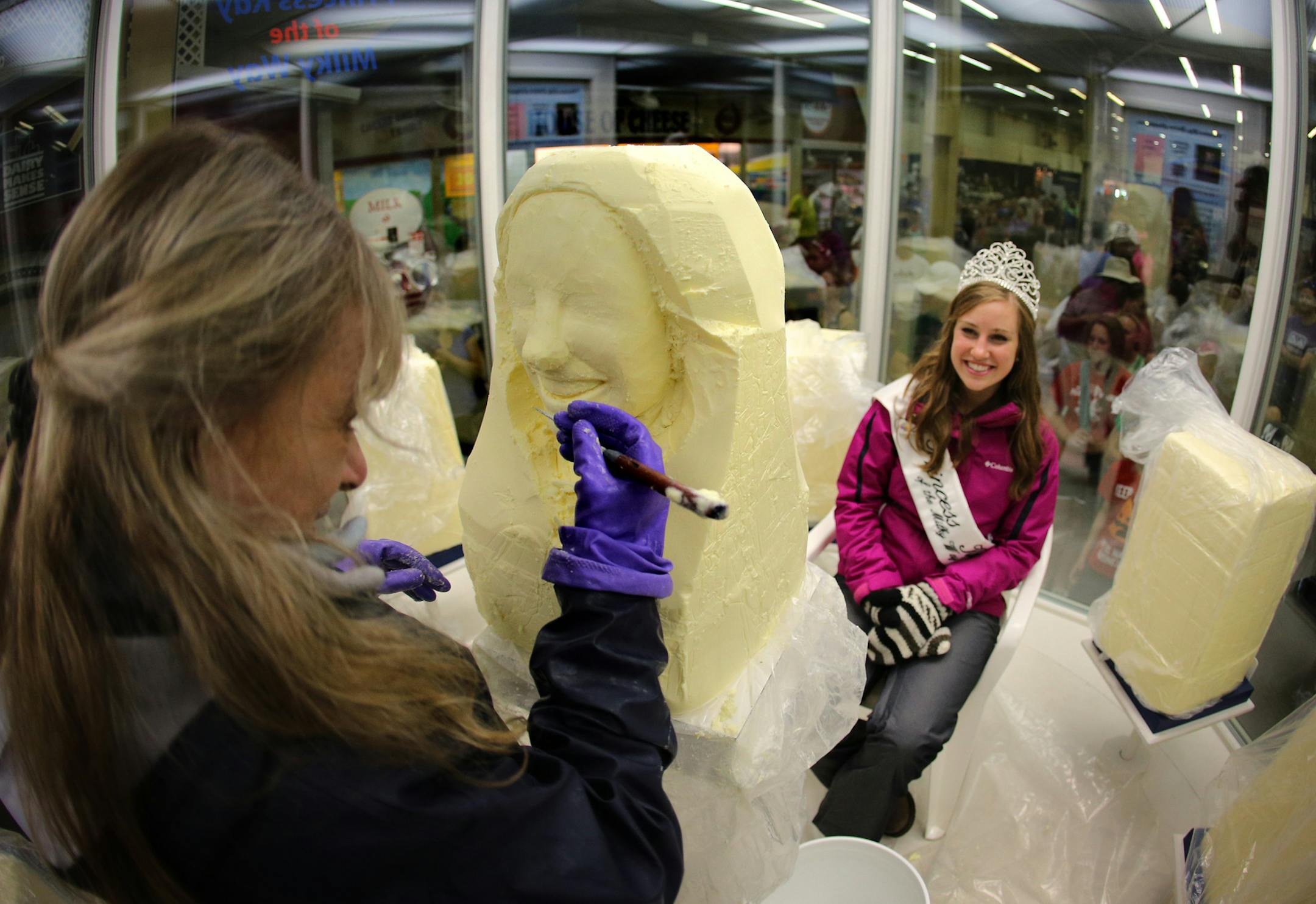 19-year-old Jeni Haler, the Princess Kay of the Milky Way _ the state's dairy queen _ sits in the chilled confines of the butter sculpting cooler to get her official butter head sculpted by Linda Christensen for the Minnesota State Fair in Falcon Heights, Minn. Butter sculptures began at the Minnesota State Fair in the late 1800s but it wasn't until 1965 that the tradition of carving the heads of the dairy princess began, which is now one of the fair's most popular exhibits according to a fair s