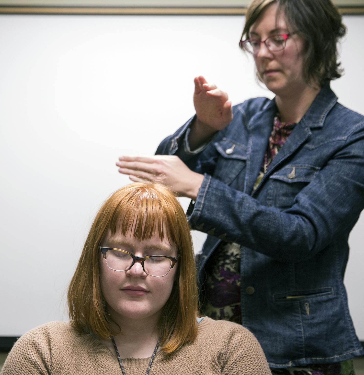 Librarian Kristen Mastel conducted a reiki session with student Grace Palmer.