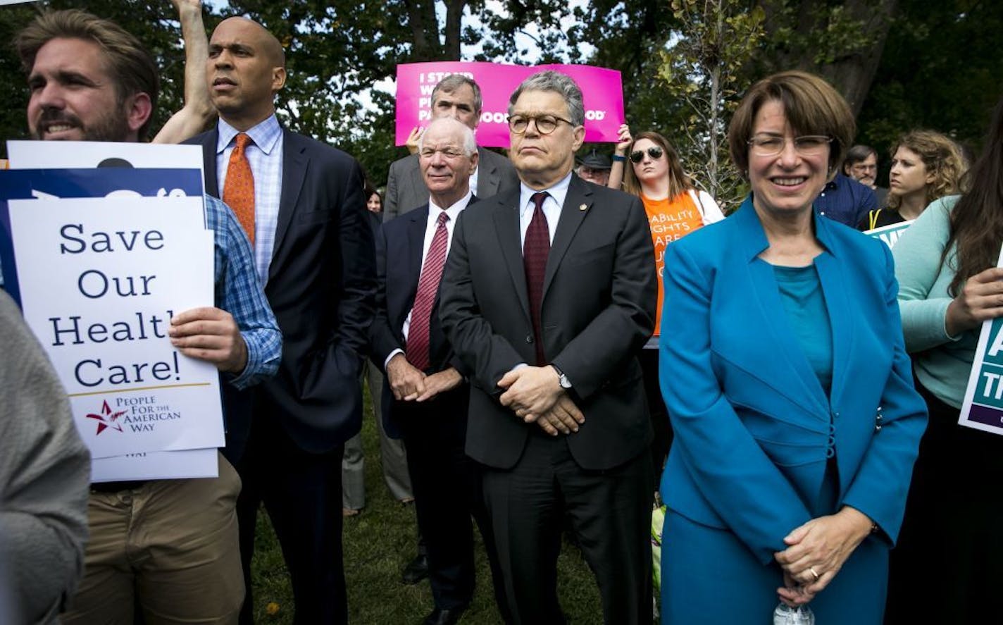 Democratic senators attend at a rally opposing renewed Republican efforts to repeal the Affordable Care Act, on Capitol Hill in Washington, Sept. 19, 2017. A bill sponsored by Sens. Lindsey Graham and Bill Cassidy could see millions lose coverage. From left: Sens. Cory Booker (D-N.J.); Ben Cardin (D-Md.); Jeff Merkley (D-Ore.) (standing behind); Al Franken (D-Minn.) and Amy Klobuchar (D-Minn.)