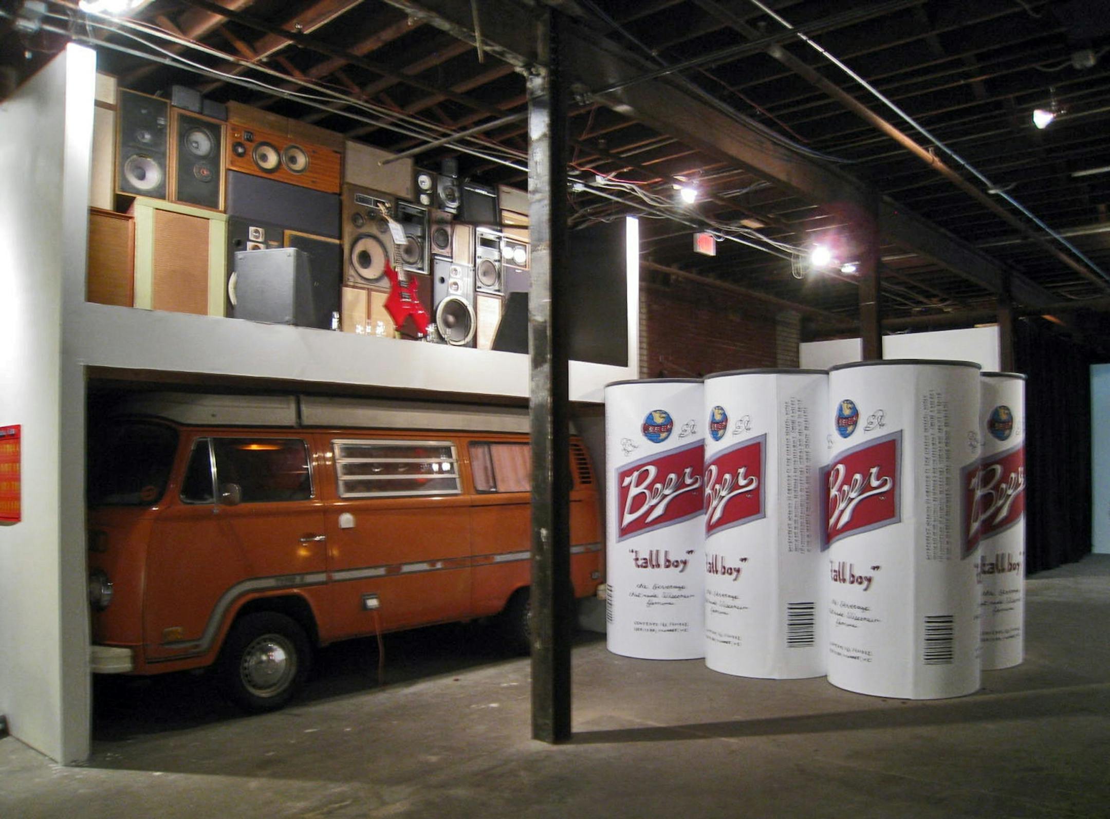 A six-pack of "tall boys," a van and a wall of speakers are part of Andy Ducett's "Why We Do This" installation at the Soap Factory in Minneapolis.