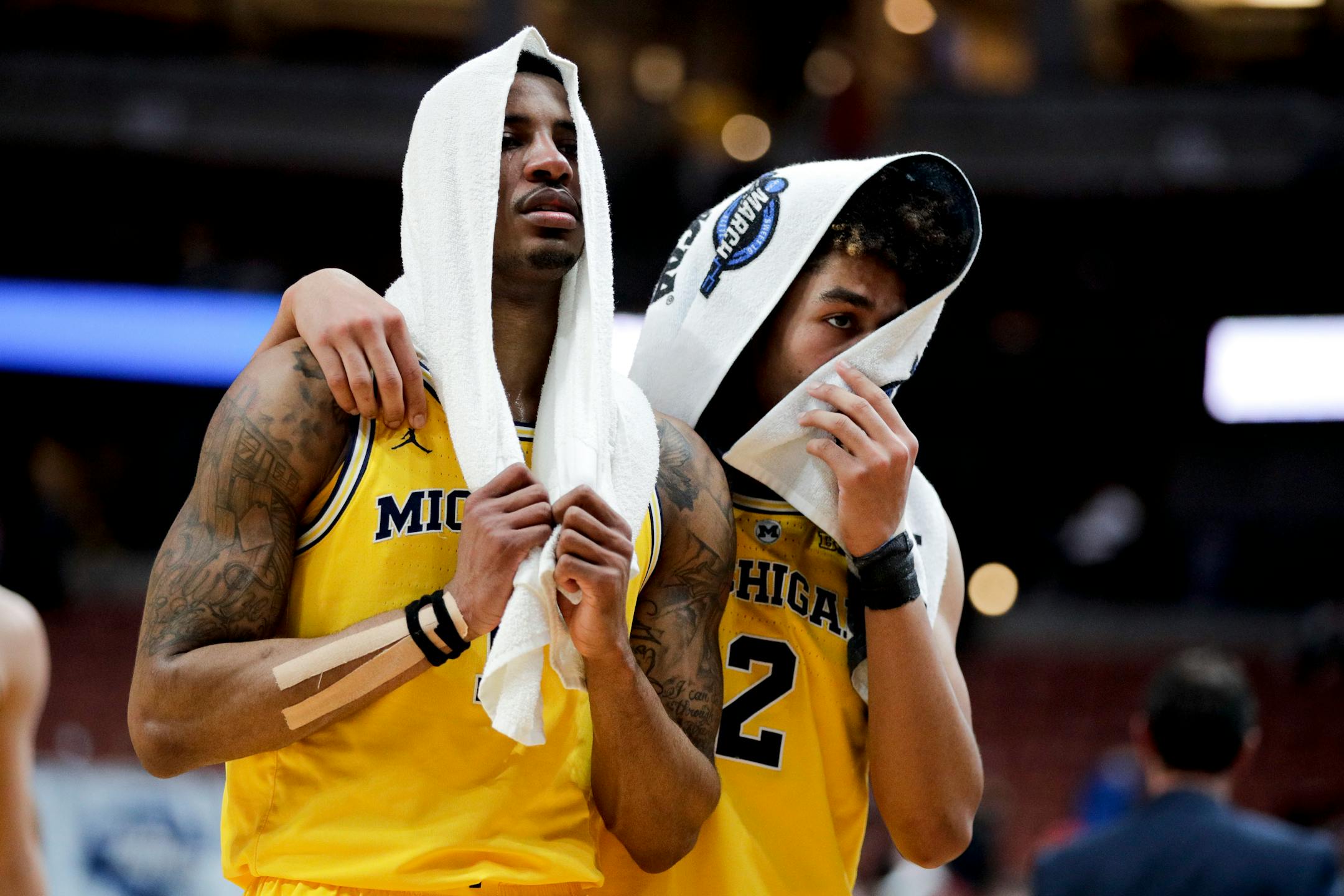 Michigan guard Charles Matthews, left, and guard Jordan Poole leave the court after the team's loss to Texas Tech during an NCAA men's college basketball tournament West Region semifinal Thursday, March 28, 2019, in Anaheim, Calif. (AP Photo/Jae C. Hong)