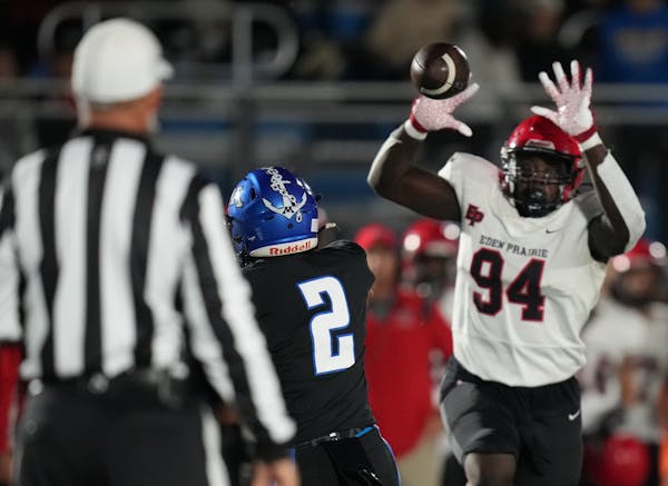 Mo Saine, right, helped lead Eden Prairie to the Class 6A quarterfinals. The defensive lineman has verbally committed to the Gophers.
