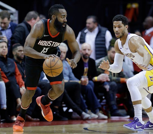 Houston Rockets guard James Harden (13) looks for a way around Los Angeles Lakers guard Josh Hart (5) in the first half of an NBA basketball game Sund