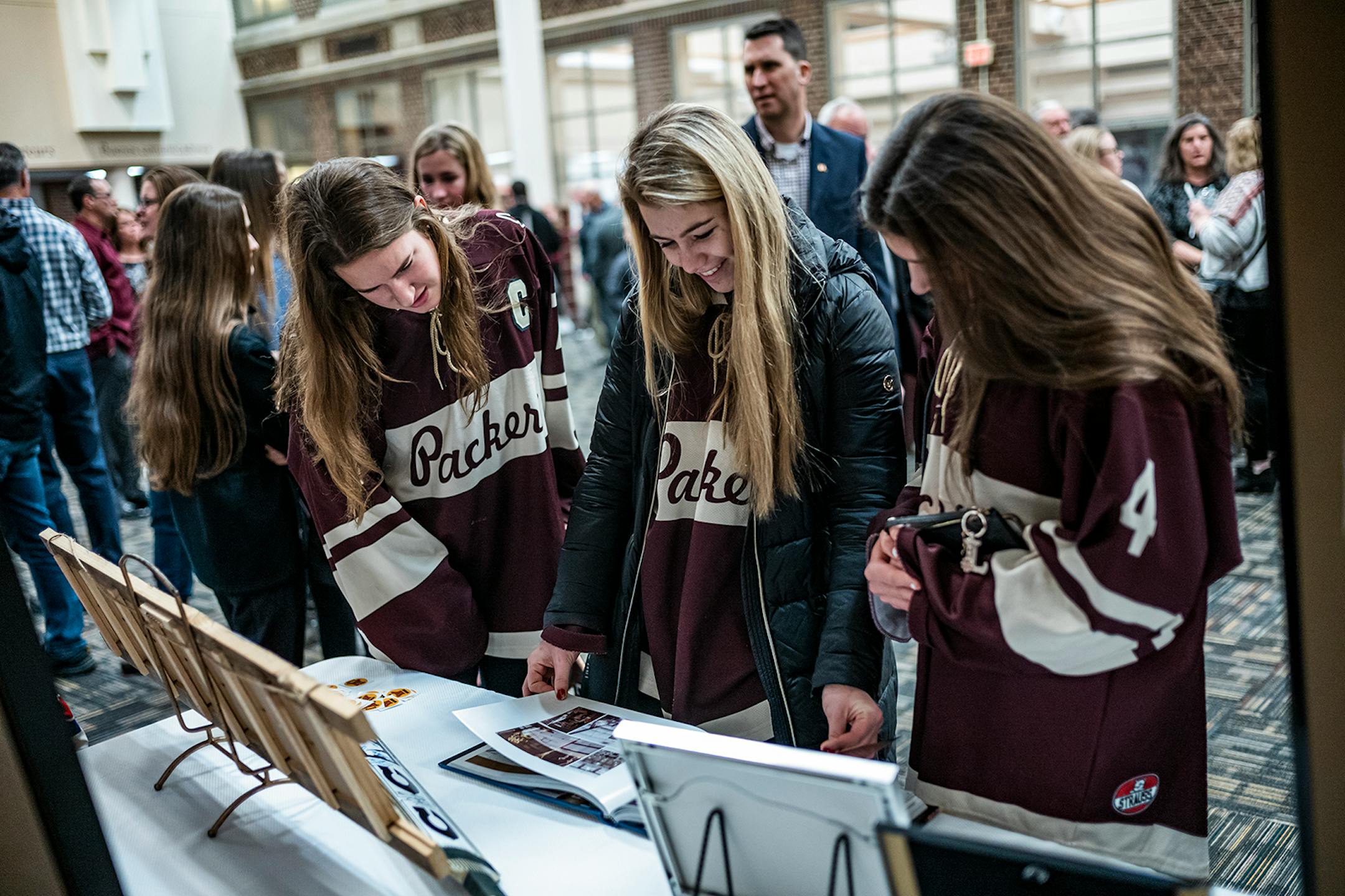 Plenty of hockey memories were on display. Lillie Kirchner, left, Makenna Deering, and Lillie Ramirez of the South St. Paul girls' hockey team attended a celebration of Gophers hockey legend Doug Woog at South St. Paul High School.