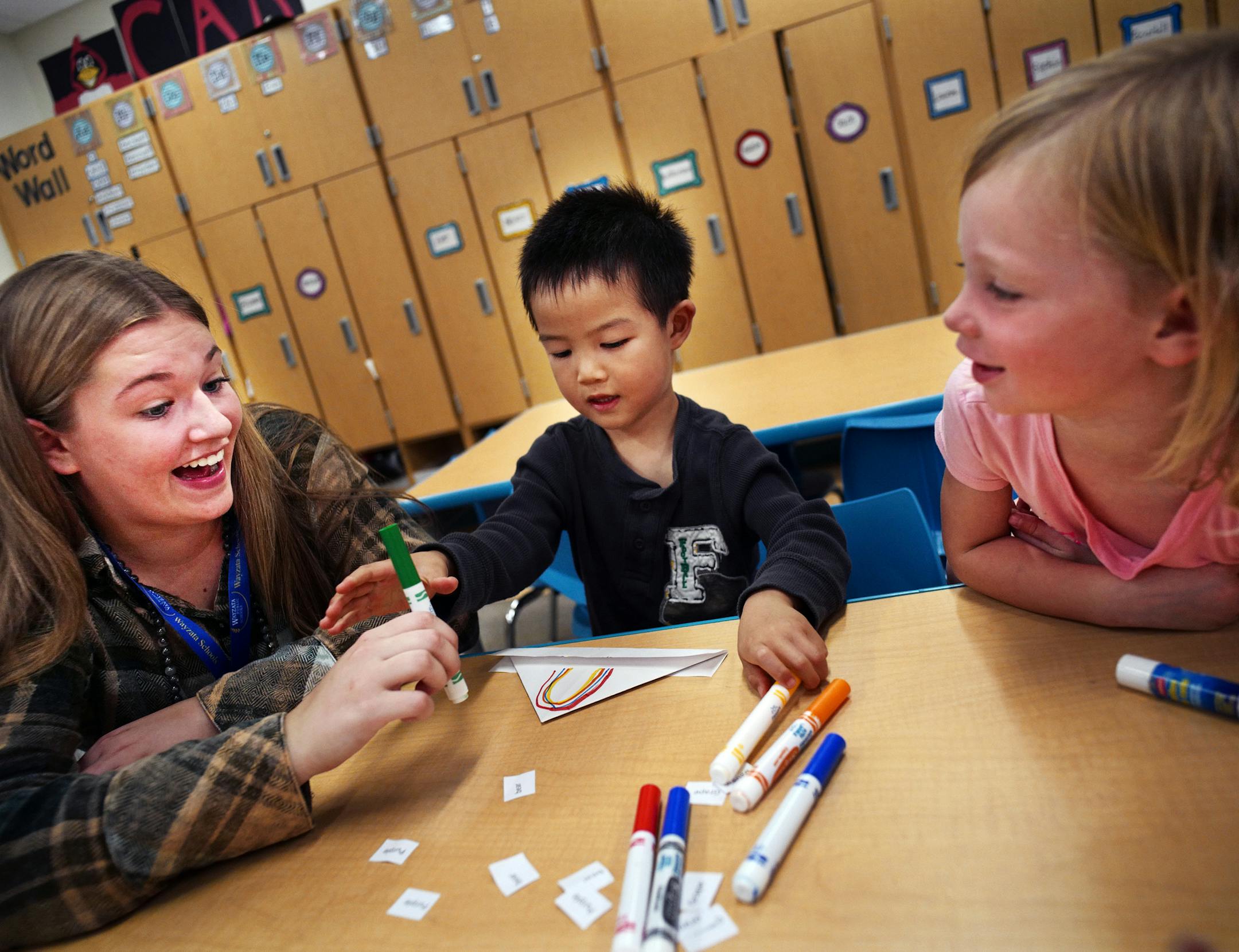 Ali Voller,17 of Wayzata H.S. helped Andrew Zhang and Lauren Schaeffer with color markers in the pre-K class in Janna Oja's class at Meadow Ridge Elementary in Plymouth. ] The Wayzata school district launched a high school class to fill the increasing shortage of part-time employees and the growth in its district. In the class, students are assigned to an elementary school where they supervise and instruct elementary students until their parents can pick them up.Richard Tsong-Taatarii/rtsong-taa