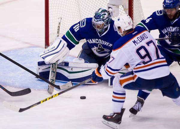 Canucks goaltender Ryan Miller made a save against the Oilers' Connor McDavid (97) in a Oct. 18 game.