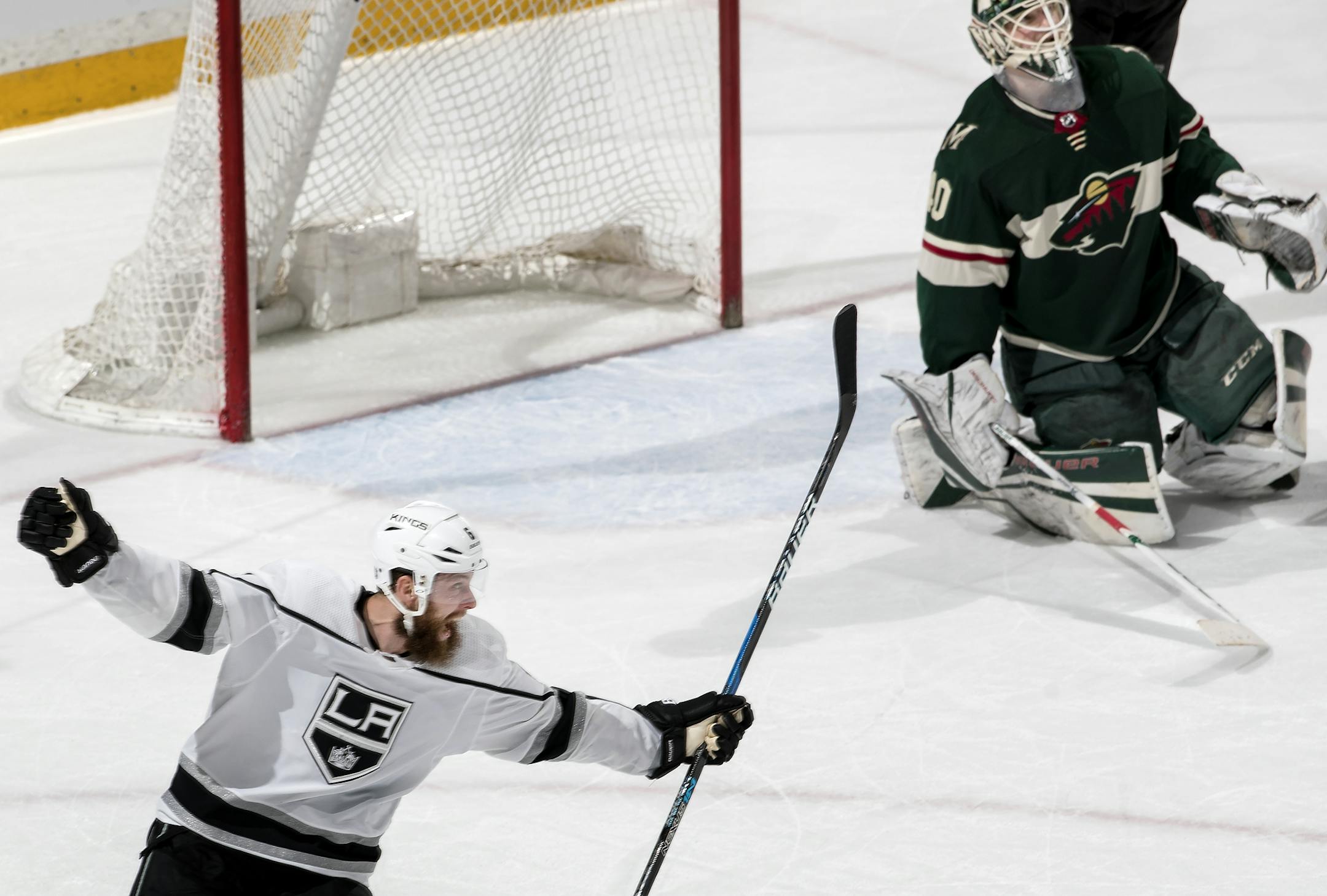 The Kings' Jake Muzzin celebrated an overtime goal by teammate Jeff Carter as Los Angeles beat the Wild 4-3 at Xcel Energy Center on Monday.