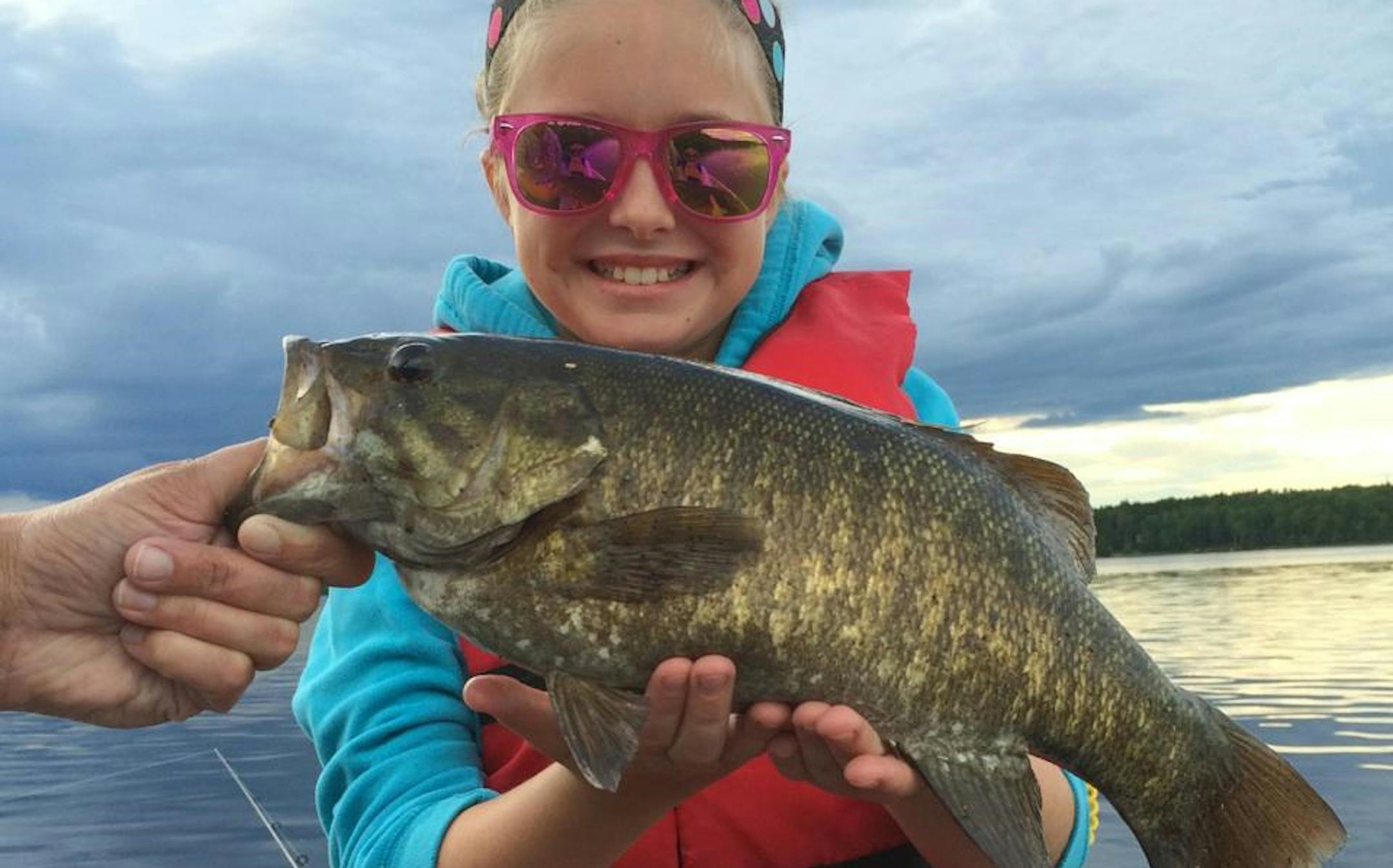 ONE NICE BASS-- Baylee O'Donnell, 11, of Richfield, caught and released this dandy smallmouth bass while fishing on Ash Lake during her family vacation.