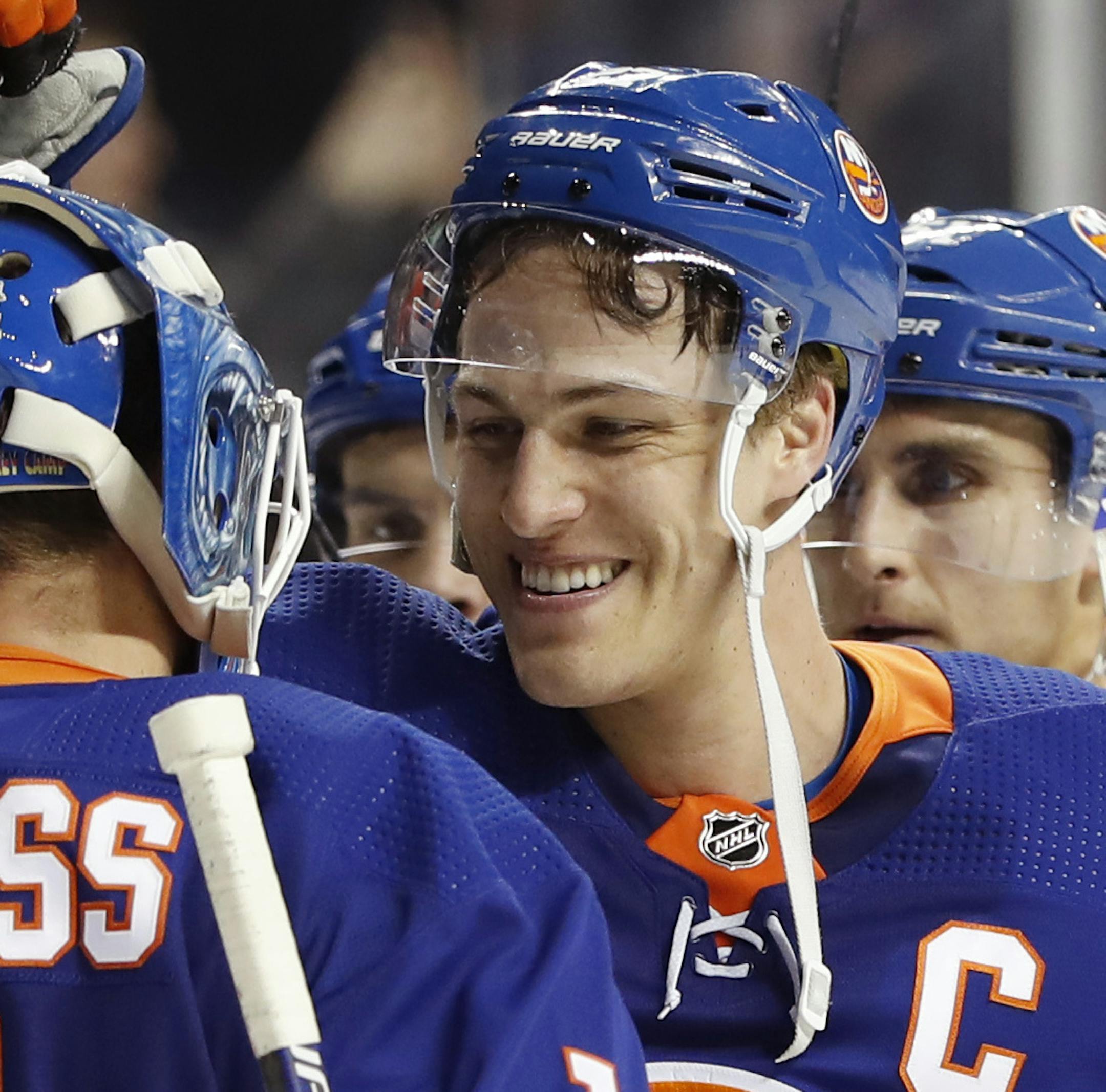 New York Islanders left wing and captain Anders Lee congratulates New York Islanders goaltender Thomas Greiss (1) of Germany after an NHL hockey game against the Minnesota Wild, Sunday, Feb. 10, 2019, in New York. The Islanders defeated the Wild 2-1. New York Islanders right wing Jordan Eberle (7) is at left. (AP Photo/Kathy Willens) ORG XMIT: MERd4743897a46959419def79c5cf7f7