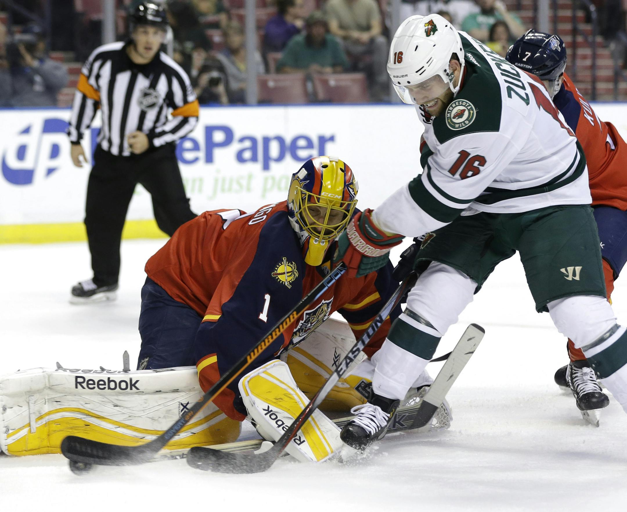 Minnesota Wild left wing Jason Zucker (16) attempts a shot on the goal as Florida Panthers goalie Roberto Luongo (1) defends during the first period of an NHL hockey game, Monday, Nov. 24, 2014, in Sunrise, Fla.(AP Photo/Lynne Sladky)