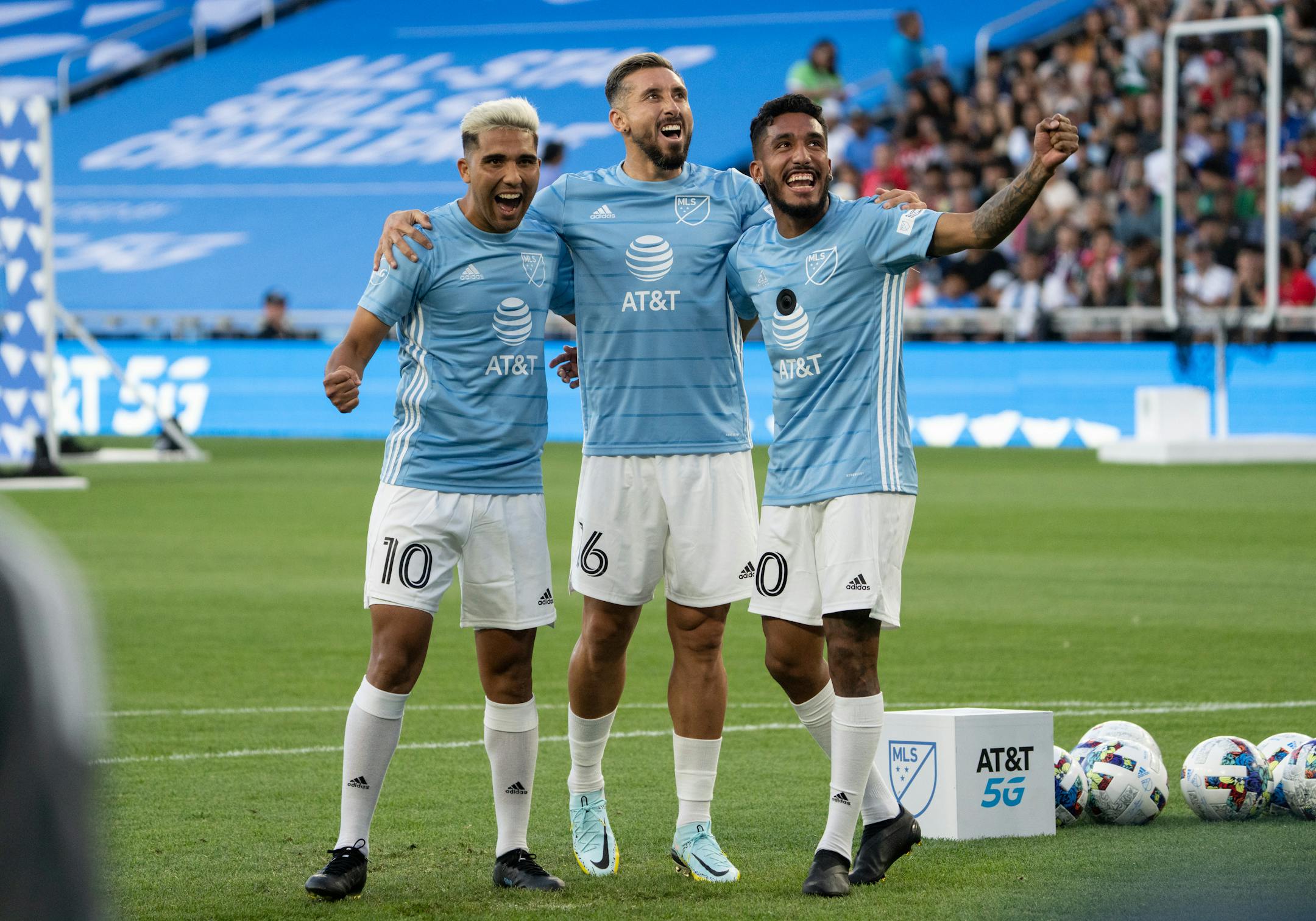 Minnesota United FC midfielder Emanuel Reynoso, Houston Dynamo FC midfielder Hector Herrera and FC Dallas forward Jes's Ferreira  celebrate winning the shooting challenge 136-74 against Liga MX.