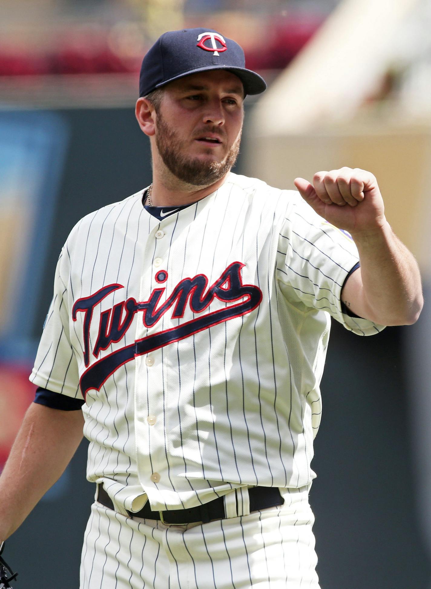 Minnesota Twins' pitcher Glen Perkins goes up to high-five catcher Eric Fryer after they defeated the Cleveland Indians 3-1 in a baseball game on Wednesday, July 23, 2014, in Minneapolis. Perkins picked up the save. (AP Photo/Jim Mone)