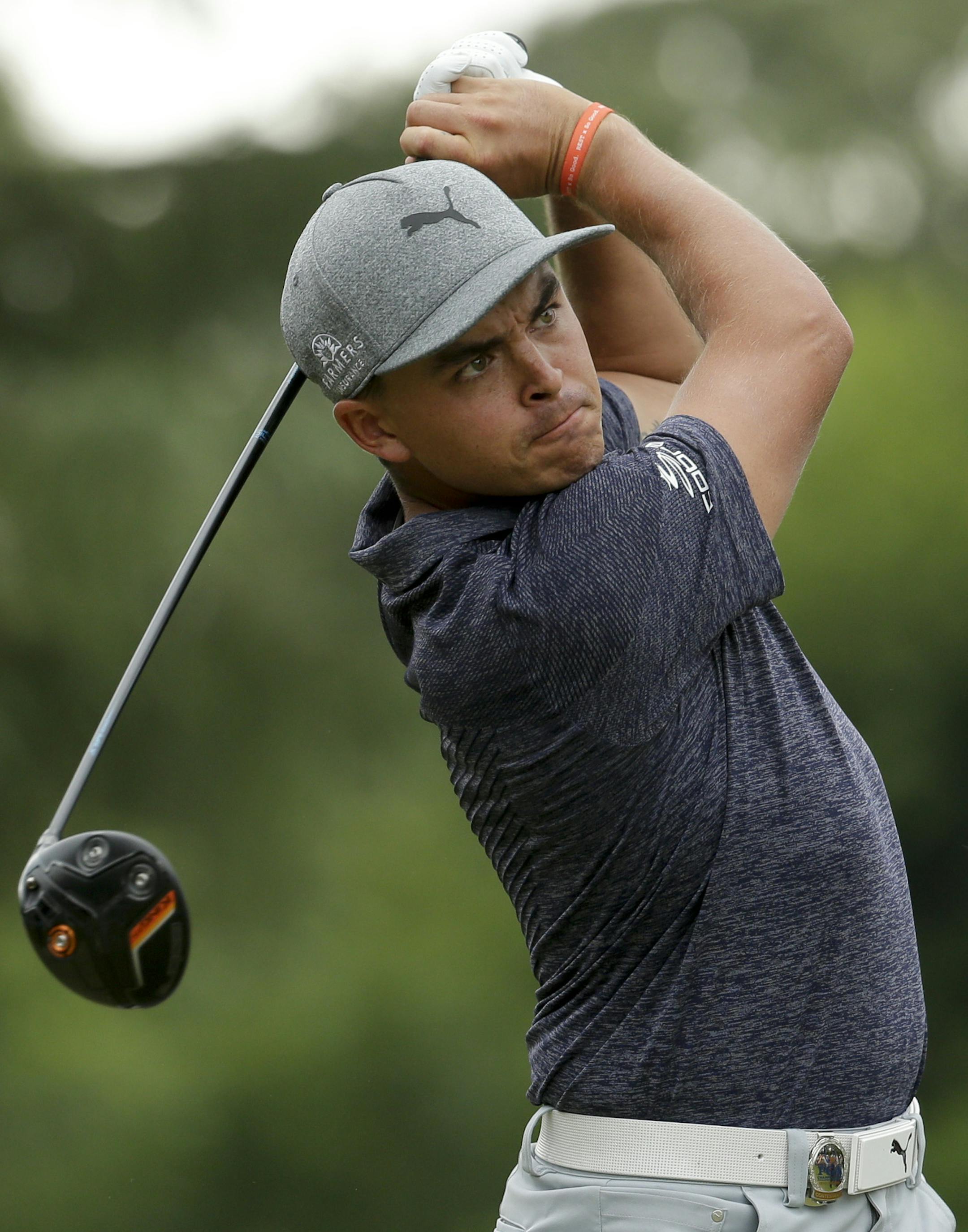 Rickie Fowler watches his tee shot on the ninth hole during the first round of the PGA Championship golf tournament at the Quail Hollow Club Thursday, Aug. 10, 2017, in Charlotte, N.C. (AP Photo/Chuck Burton)