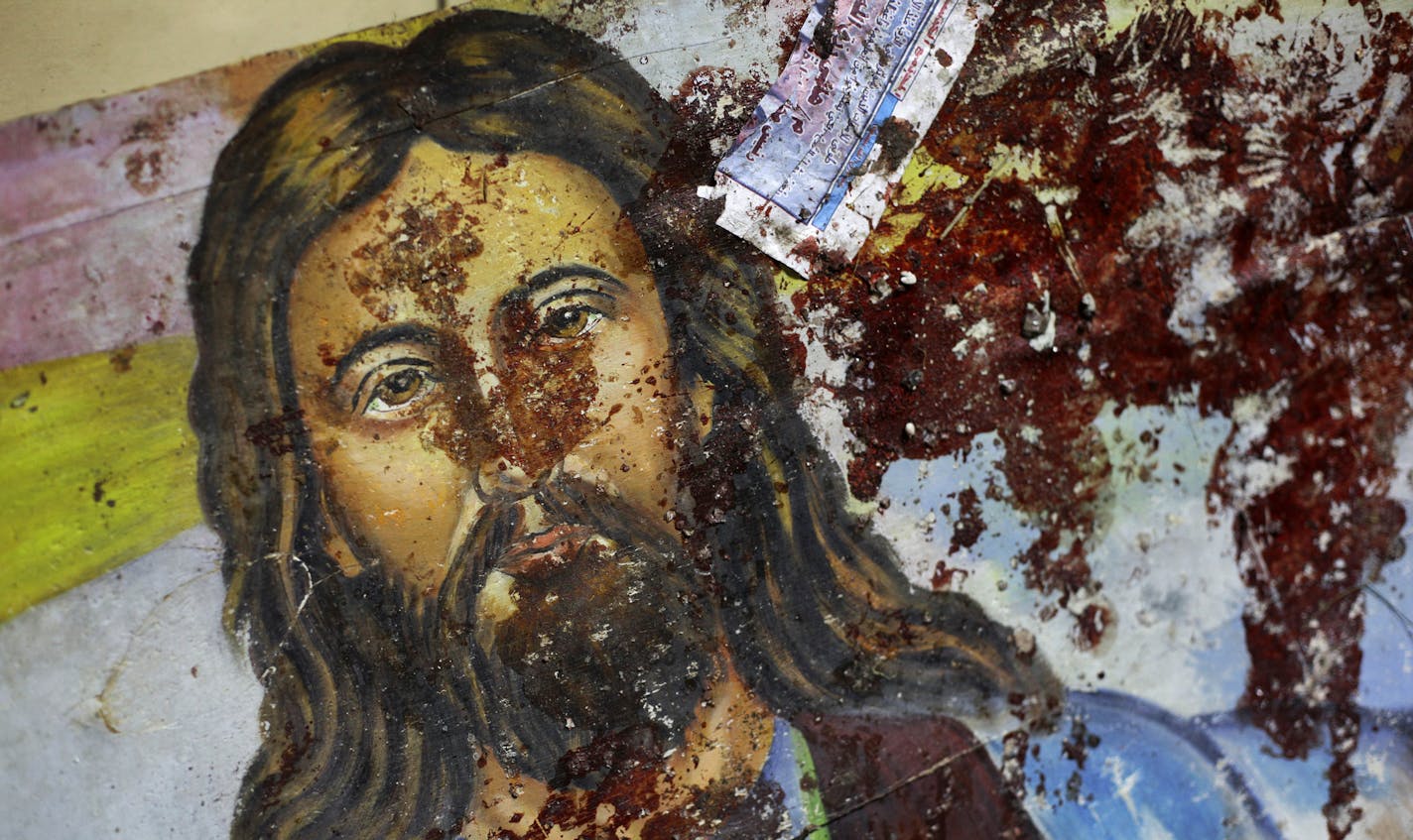 A blood-spattered poster of Jesus Christ is seen inside the the Coptic Christian Saints Church in the Mediterranean port city of Alexandria, Egypt Saturday, Jan. 1, 2011. A car exploded in front of the church early Saturday as worshippers emerged from a New Year's Mass, killing at least 21 people according to officials, and sparking clashes between Christians and Muslims _ a sign of the sectarian anger that has been arising with greater frequency in Egypt. (AP Photo/Ben Curtis)