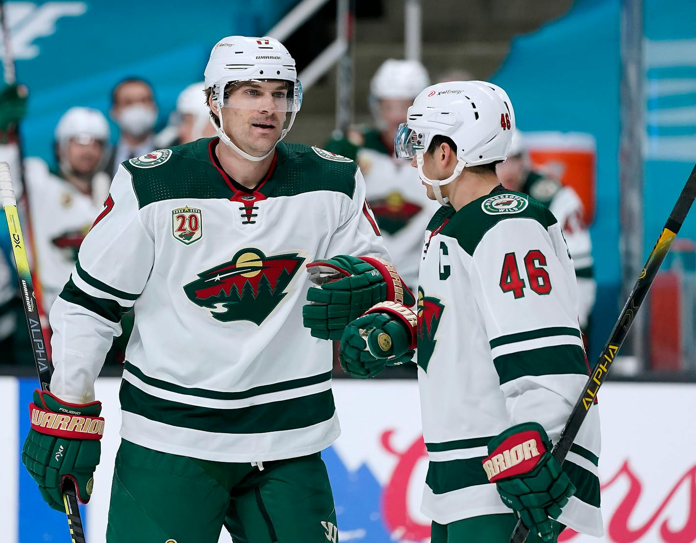 Minnesota Wild left wing Marcus Foligno (17) is congratulated by teammate Jared Spurgeon (46) after scoring a goal against the San Jose Sharks during the second period of an NHL hockey game in San Jose, Calif., Monday, Feb. 22, 2021. (AP Photo/Tony Avelar)