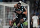 The Loons' Bongokuhle Hlongwane leaps on Teemu Pukki to celebrate during a game last season. Each scored Saturday night in Orlando.