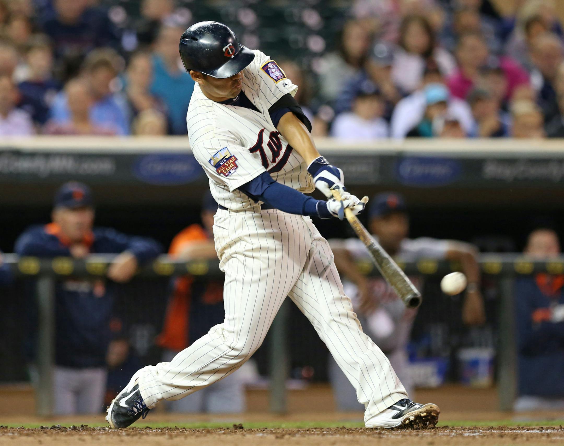 Minnesota Twins' Kurt Suzuki hits an RBI double off Detroit Tigers pitcher David Price in the first inning of a baseball game, Wednesday, Sept. 17, 2014, in Minneapolis. (AP Photo/Jim Mone)