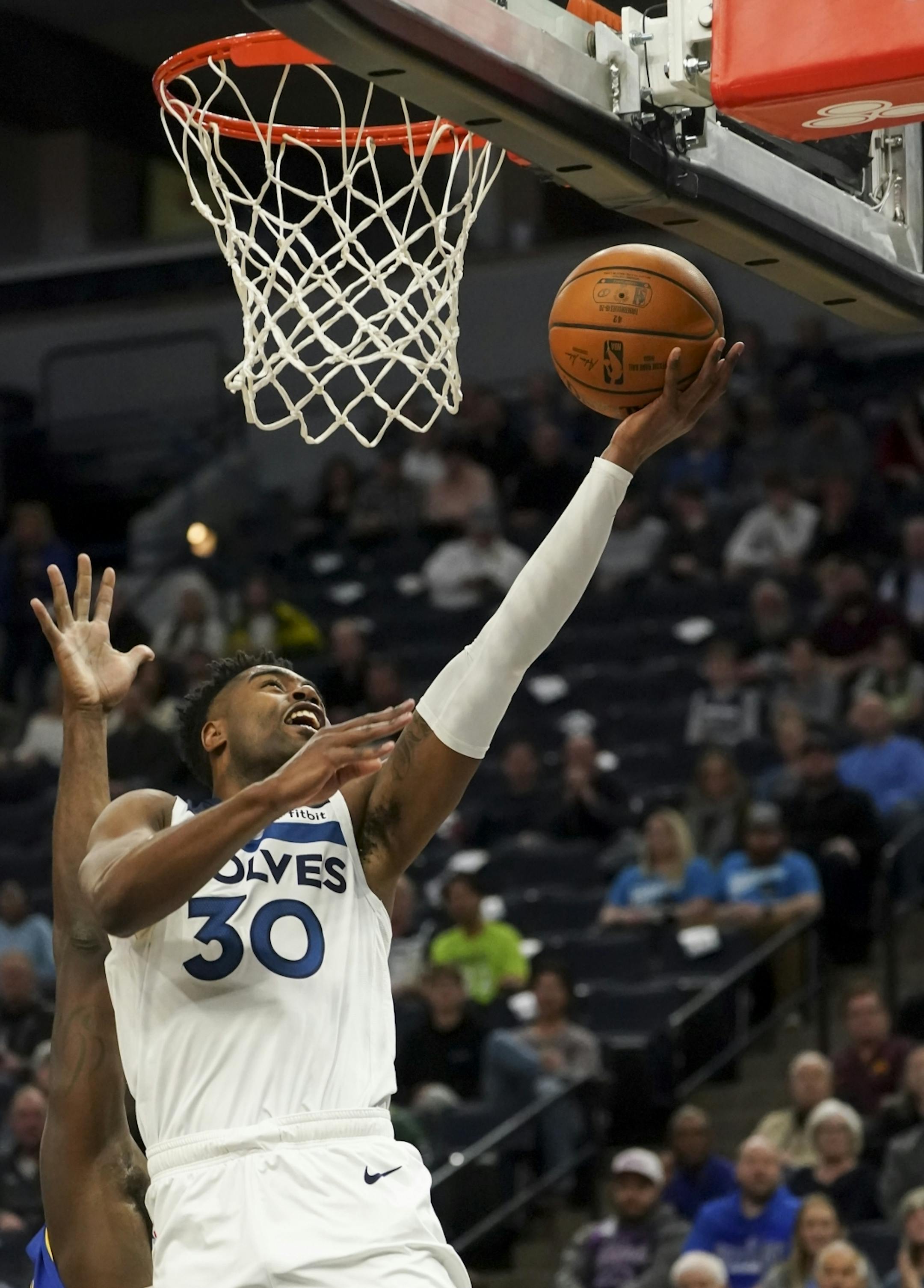 Minnesota Timberwolves forward Kelan Martin (30) jumped for a shot in the first half.