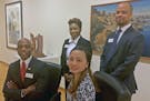 The Wells Fargo employees are Tommy Redae (seated, left), Ursula McNeal (standing) , Jonathan Meachum (standing) and Choua Lo, (seated, right).