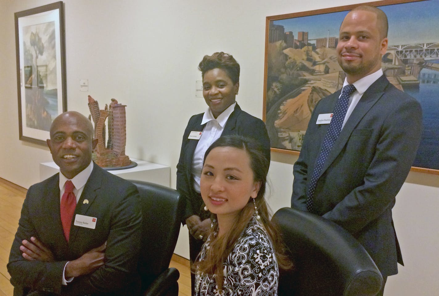 The Wells Fargo employees are Tommy Redae (seated, left), Ursula McNeal (standing) , Jonathan Meachum (standing) and Choua Lo, (seated, right).