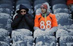 Fans wait in the snow covered seats before an NFL football game between the Chicago Bears and the Denver Broncos, Sunday, Nov. 22, 2015, in Chicago.